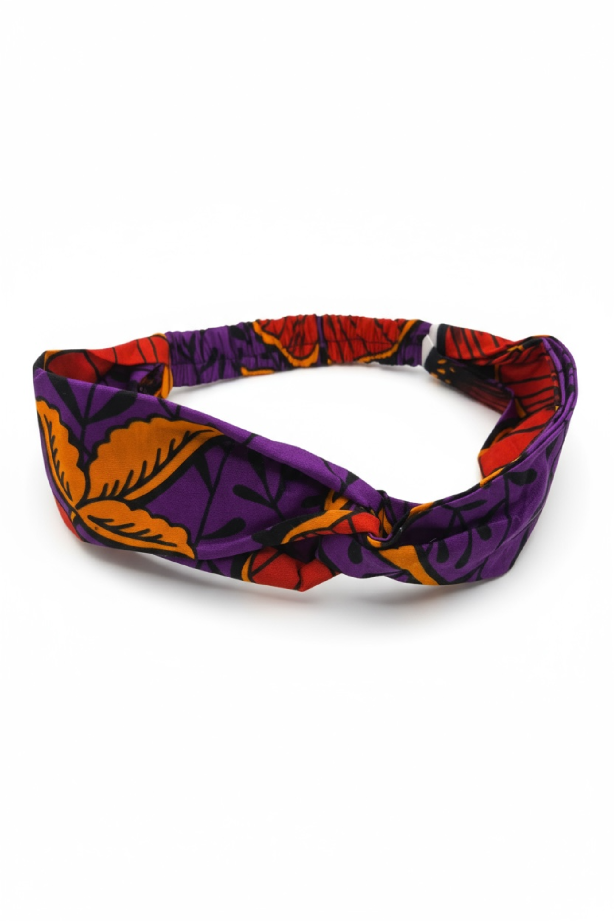 Détail des motifs floraux violet, orange et rouge du bandeau en wax africain Makomie